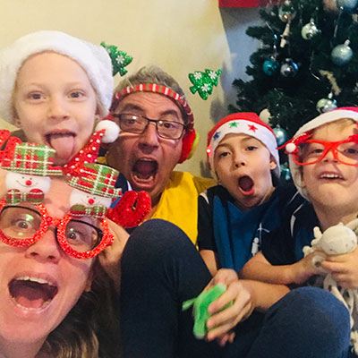 A photo of an expat family at Christmas smiling and excited